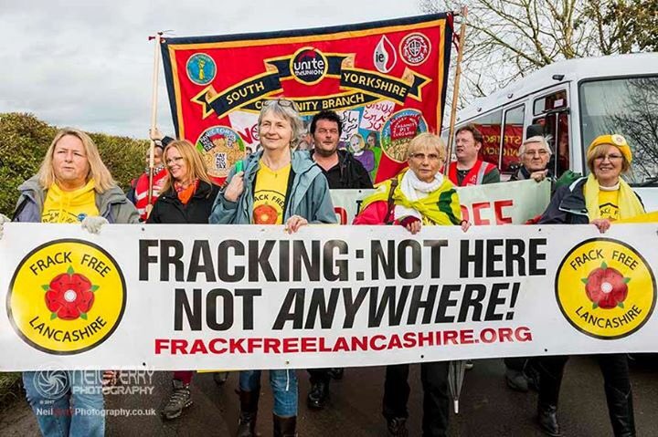 Frack Free Lancashire protesters marching in Kirby Misperton, holding a banner